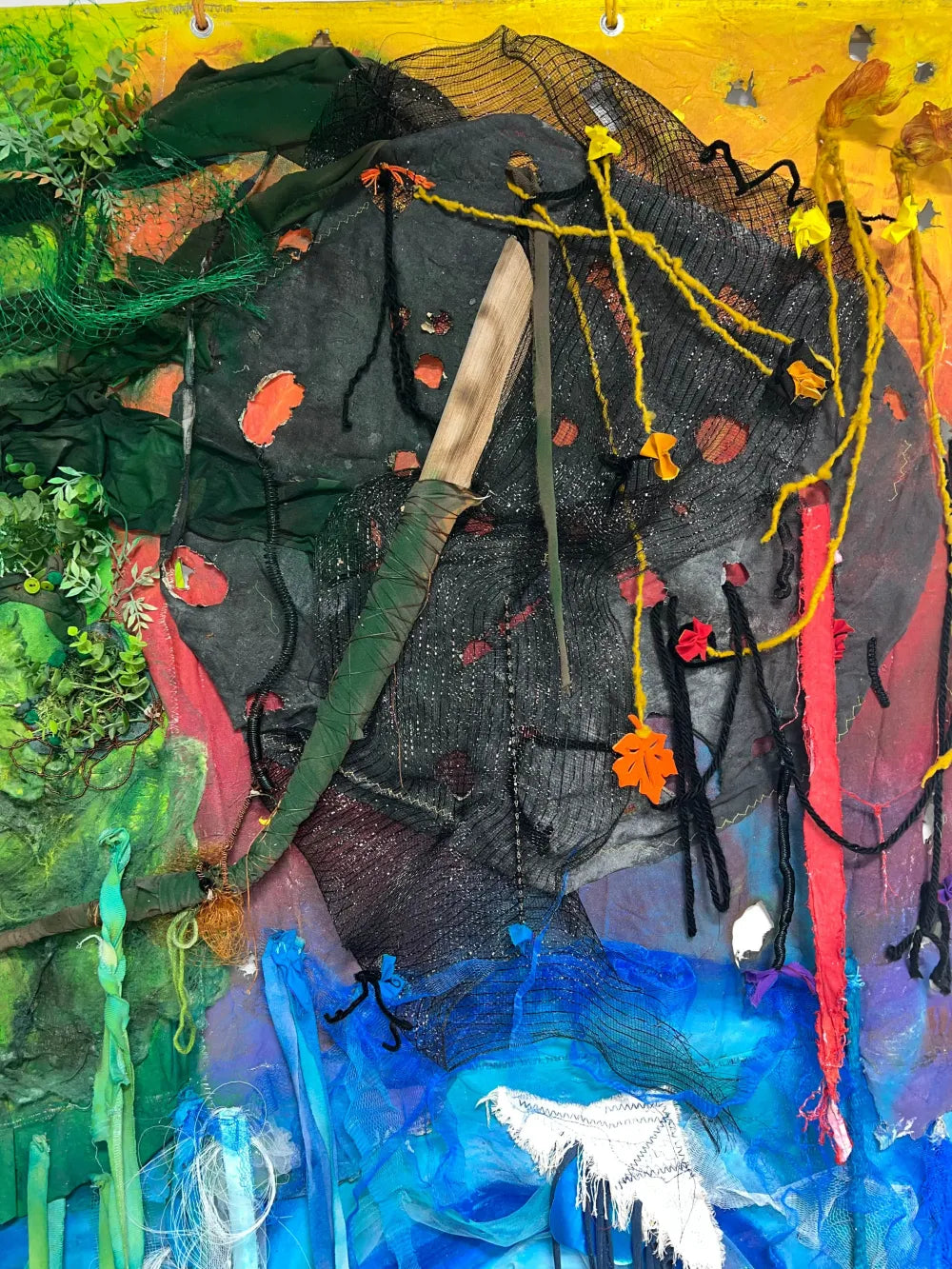 Fire element represented with dark netting and repurposed materials in Echoes of Nature